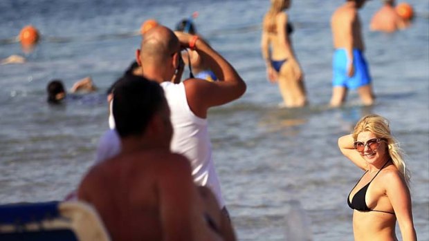 A tourist takes a photo at the Red Sea resort of Sharm el-Sheikh ... industry professionals say beach holidays make up as much as 80 per cent of Egyptian tourism, a sector that became vital during the Mubarak era, when a chain of resorts were built from Sinai further south down the Red Sea coast.