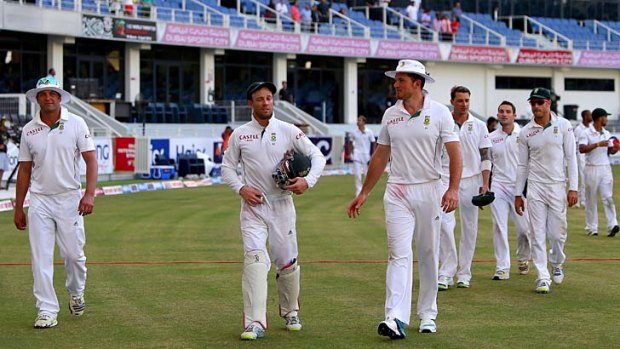 South African cricketers return to the pavilion after winning the second Test against Pakistan in Dubai on Saturday. Only five black Africans have played for the national side since 1991 when the country was accepted into international competitions.