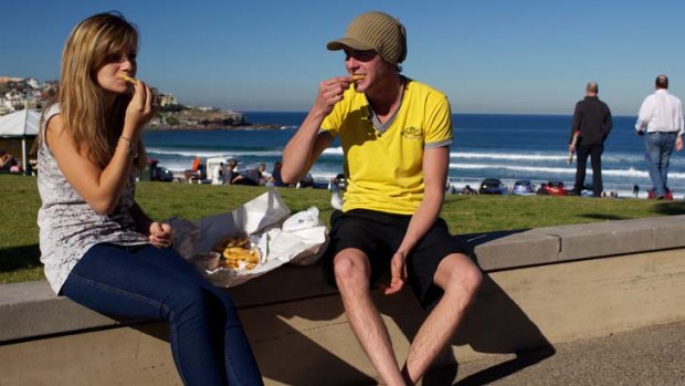 Fish fans ... Ramara Mexis, 20, and Robin Ziehlke, 22, from Germany eat food from Bondi Surf Seafoods.