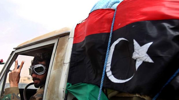 Heavy fighting ... a Libyan rebel leaves the eastern town of Ajdabiya.