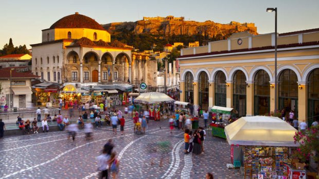 Pillar talk: People bustle through Monastiraki market.