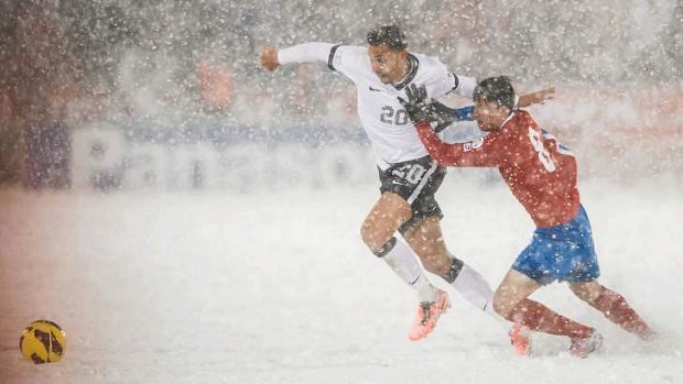 Snow joke ... the USA and Costa Rica play in a blizzard.