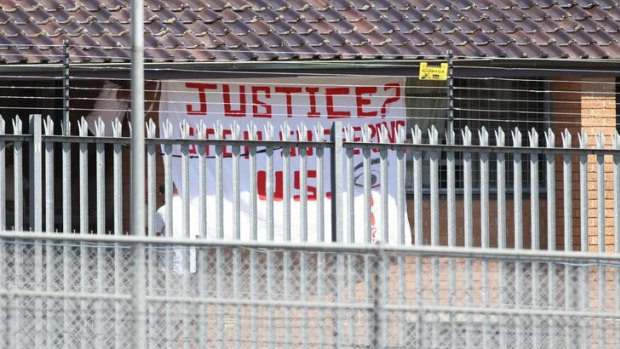 A protest flag is displayed at Villawood detention centre last year.