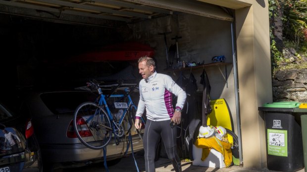 Tony Abbott returns home after a bike ride and a swim on Sunday. 