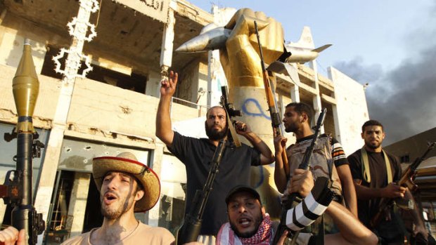 Libyan rebels celebrate the fall of the Gaddafi regime at Bab Al-Aziziya compound in Tripoli August 23, 2011.