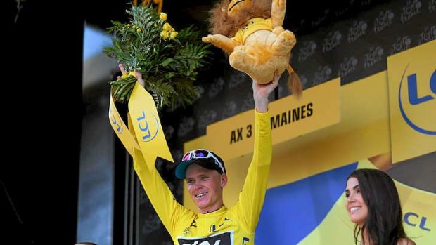 New race leader Chris Froome (Great Britain), from Team Sky, celebrates on the podium after winning stage eight of the 2013 Tour de France.