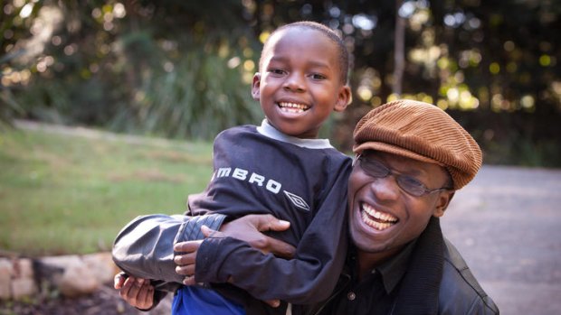 Pastor Peter Sewakiryanga and George, 5, who has had surgery in Brisbane to repair the horrific injuries a witch doctor inflicted on him.