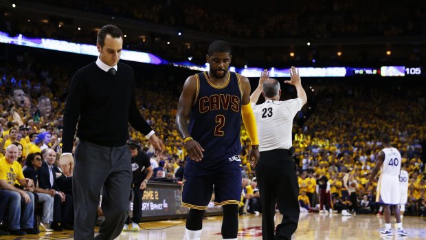 Hobbling off: Kyrie Irving leaves game one with his knee injury.