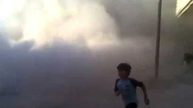 This frame grab  from an amateur video provided by Syrian activists on Monday, purports to show a boy running during the massacre in Houla on May 25. AP has been unable to verify its authenticity.