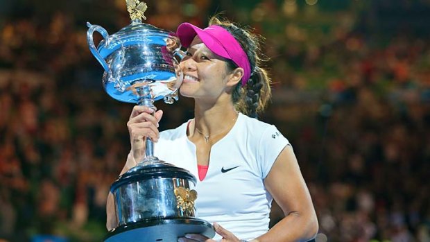 Li Na kisses her trophy after defeating Dominika Cibulkova in straight sets in the final.