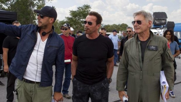 Australian director Patrick Hughes, left, with Arnold Schwarzenegger and Harrison Ford on the set of <i>The Expendables 3</i>, a film that has reportedly been illegally downloaded more than 10 million times.