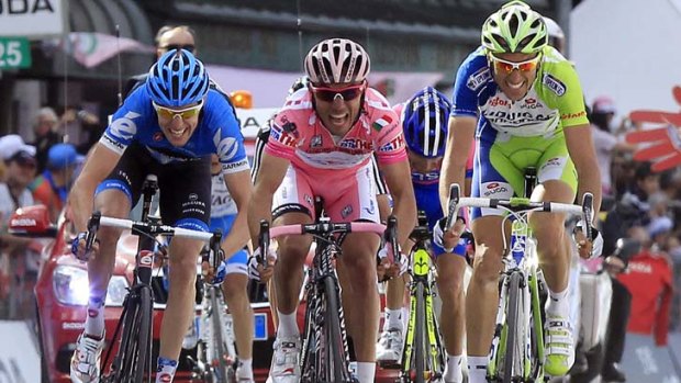 Pink slip &#8230; Joaquim Rodriguez outsprints Ryder Hesjedal, left, and Ivan Basso, right, to win the 186-kilometre 17th stage in Italy's Dolomites mountains.