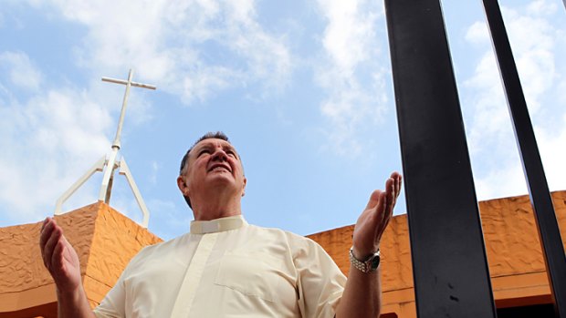 No way in ... Monsignor Brian Rayner outside the church from which he banned the Greens.