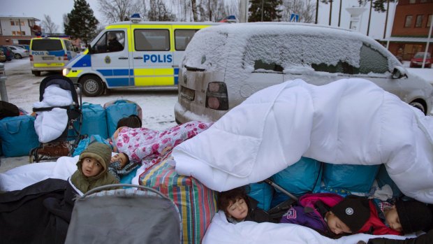 Migrant children from Syria sleep outside the Swedish Migration Board, in Marsta, Sweden. 