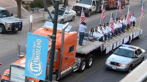 A flatbed truck carries wounded veterans and their families during a parade before it was struck by a train in Texas.