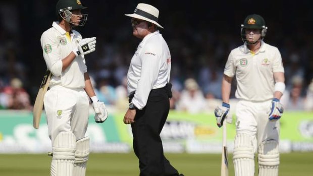 Ashton Agar (L) talks to umpire Marais Erasmus as he leaves the field at Lord's after being ruled out caught behind despite Hot Spot not showing a mark.