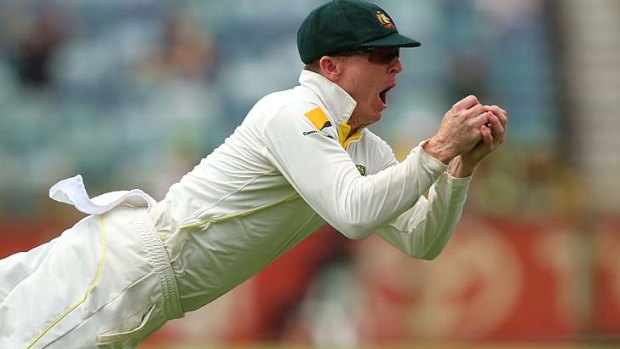 Well held: Chris Rogers takes a diving catch to dismiss Tim Bresnan in Perth.