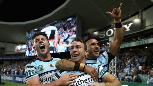 Party time: Chad Townsend, James Maloney and Valentine Holmes celebrate during last year's successful finals campaign.