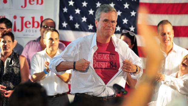 Does anyone remember? Republican presidential candidate and former Florida governor Jeb Bush shows off a reminder of the Reagan/Bush '84 campaign.