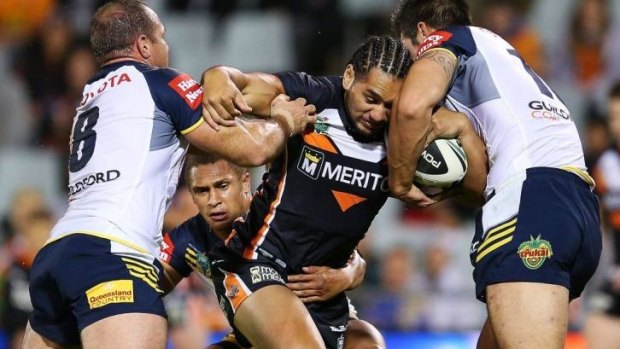 Clinical: Martin Taupau of the Tigers goes into contact.