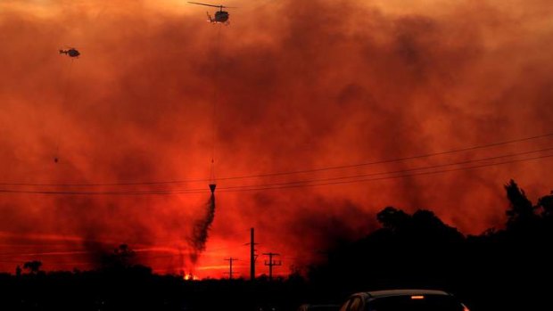 Helicopters drop water on a fire at Doyalson, NSW.