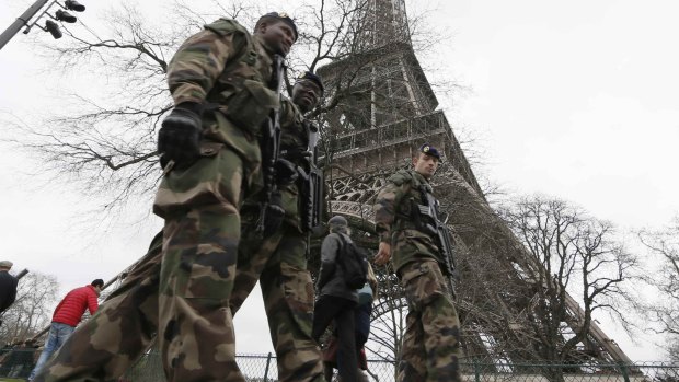 French soldiers patrol near the Eiffel Tower in Paris. 