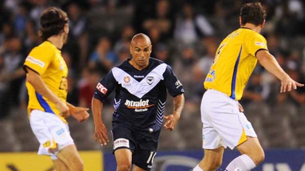 Victory striker Archie Thompson, who returned from a long absence following knee surgery, takes on Gold Coast defenders last night.