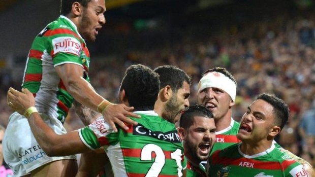 Victory: The Rabbitohs celebrate with Greg Inglis after the fulltime siren.