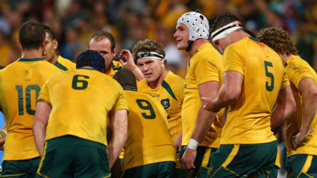 Looking for answers: Michael Hooper, centre, and Wallabies teammates during the loss to the Springboks in Brisbane earlier this month.