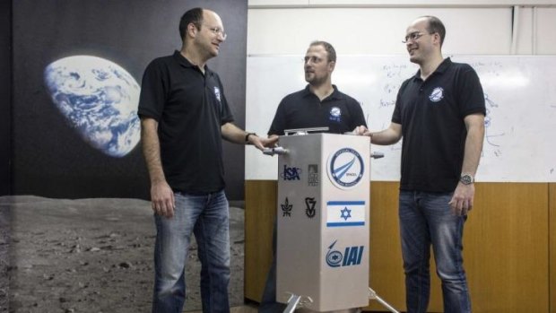 Yariv Bash (left) with his company's spacecraft  prototype at Bar-Ilan University, near Tel Aviv.