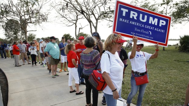 Trump supporters line up for a rally in Florida on Sunday. 