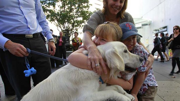 Good influence ... Abby Matthews, 10, with her companion dog, Jemima, her brother Cameron, 6, and their mother, Rebecca.