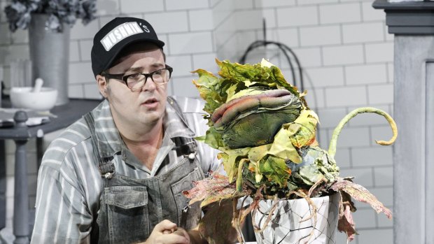 Brent Hill with Audrey II in Little Shop of Horrors.