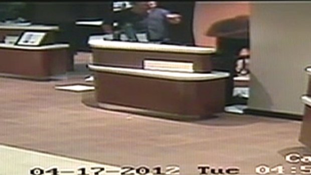 Pointing the finger ... Video footage shows a punch being thrown before the hotel worker, right,  walks away from Newton clutching his face. He later collapses on the floor.