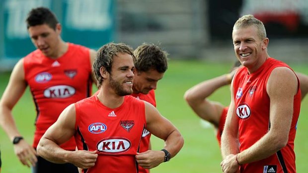 Pinching himself: Sam Lonergan (left) and Dustin Fletcher share a joke while training at Windy Hill yesterday.