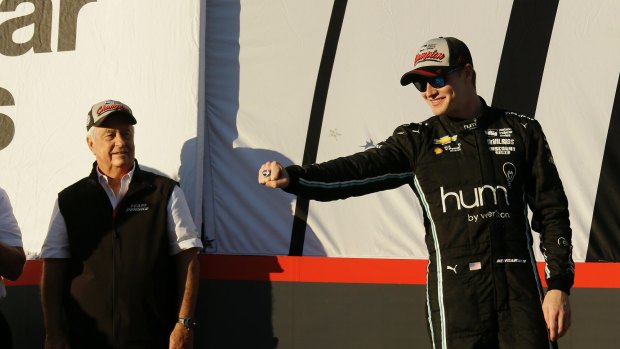 Josef Newgarden, right, shows off his new ring after winning the IndyCar championship, with team owner Roger Penske looking on.