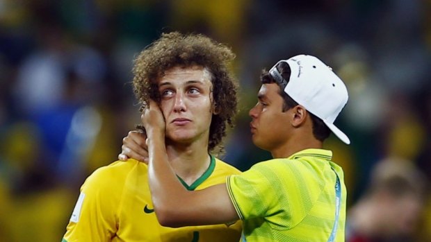 Brazilian nightmare: David Luiz is consoled by teammate Thiago Silva.