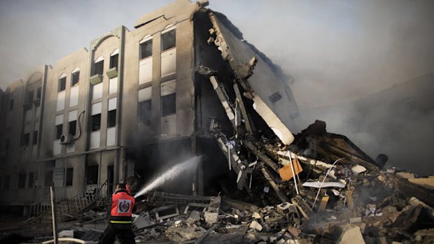 Firefighters in Gaza try to extinguish a fire at the Ministry of Interior after it was hit by an Israeli missile on Friday.