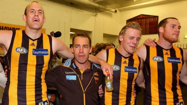 Alastair Clarkson (second from left) joins his team in the rooms to sing the club song.