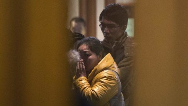 In shock ... A Chinese relative of passengers aboard a missing Malaysia Airlines plane looks out from a hotel room in Beijing, China.