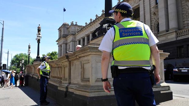 Protective services officers outside Parliament House.