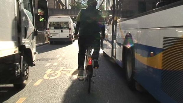 Tight squeeze: Negotiating the tight spaces between moving traffic and parked cars in the CBD bike lane is not for the weak hearted.