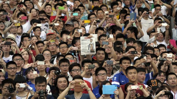 Chinese fans cheer as  David Beckham makes an appearance at Nanjing on June 18. Beckham is an ambassador for the China Super League.