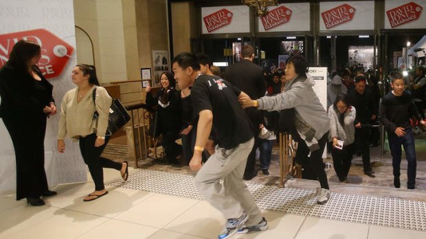 Customers storm into David Jones in Sydney on Boxing Day, 2012.
