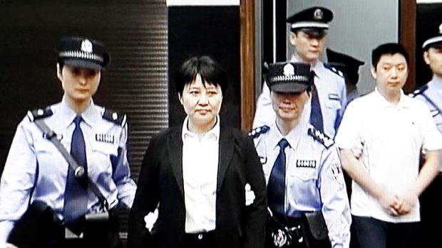 Doubts run deep ... a woman, who online activists say is not Gu Kailai, is led to court in Hefei.