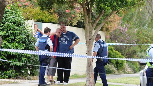 Onlookers at the scene of the fatal shooting in Mulgrave, where a woman died on the footpath.