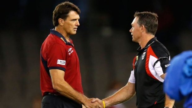 Rival coaches Paul Roos of the Demons and Alan Richardson of the Saints shake hands before the game.