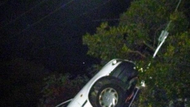 Up, up and away ... The driver and two passengers were forced to climb down from the crashed car at Ormond.