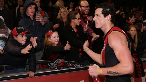 Jake Carlisle greets Essendon fans after the game.