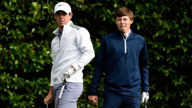 Rory McIlroy of Northern Ireland and Matthew Fitzpatrick of England wait on a tee box during a practice round yesterday.